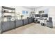 Bright home office with modern shelving, tile flooring, and a dedicated workstation at 1015 Spindle Palm Way, Apollo Beach, FL 33572