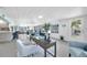 Bright and airy office space with large windows, an open layout, and a view to living spaces at 1015 Spindle Palm Way, Apollo Beach, FL 33572