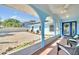 Inviting screened patio featuring tiled floors, cool blue accents, seating, and a view of the manicured landscaping at 1015 Spindle Palm Way, Apollo Beach, FL 33572