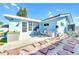 Outdoor patio area with patio seating and barbecue near a bright blue house at 1015 Spindle Palm Way, Apollo Beach, FL 33572