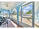 Relaxing enclosed patio with tiled floors, comfortable seating, and a view of the rock garden landscaping at 1015 Spindle Palm Way, Apollo Beach, FL 33572