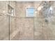 Modern shower featuring dual shower heads, tiled walls, a corner seat, and a window at 1015 Spindle Palm Way, Apollo Beach, FL 33572