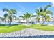 This waterfront property features a boat lift, dock, lush landscaping, and palm trees at 1015 Spindle Palm Way, Apollo Beach, FL 33572