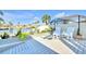 Charming waterfront features a wooden deck, lush plants, and rocking chairs overlooking the water at 1015 Spindle Palm Way, Apollo Beach, FL 33572