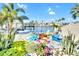 This waterfront home features a landscaped backyard, paver patio, lush plants, and a water view at 1015 Spindle Palm Way, Apollo Beach, FL 33572