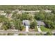 Aerial view of a two-story home on a wooded lot with mature landscaping, pool and pond at 11257 Persimmon Ave, Weeki Wachee, FL 34614