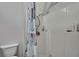 Tiled shower and toilet within the bathroom providing a clean and efficient space at 11257 Persimmon Ave, Weeki Wachee, FL 34614