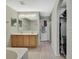 Bright bathroom featuring double sinks and a large mirror over light wood cabinets at 11257 Persimmon Ave, Weeki Wachee, FL 34614