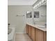 Beautiful bathroom with double sinks and an oval soaking tub under bright lighting at 11257 Persimmon Ave, Weeki Wachee, FL 34614