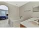 Bright bathroom boasts soaking tub, double sink vanity, and access to the main bedroom at 11257 Persimmon Ave, Weeki Wachee, FL 34614