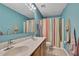 Bathroom featuring a double sink vanity, large mirror, and shower with colorful curtain at 11257 Persimmon Ave, Weeki Wachee, FL 34614