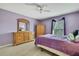 Bright bedroom featuring hardwood floors, a wooden dresser, and a serene atmosphere at 11257 Persimmon Ave, Weeki Wachee, FL 34614