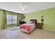 Cozy bedroom featuring a ceiling fan, window with blinds, desk area and neutral-toned walls at 11257 Persimmon Ave, Weeki Wachee, FL 34614