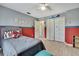 Stylish bedroom with a blend of gray, red, and blue decor and a spacious closet at 11257 Persimmon Ave, Weeki Wachee, FL 34614