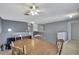 Spacious dining area features a wooden table, ceiling fan, and neutral wall paint at 11257 Persimmon Ave, Weeki Wachee, FL 34614