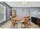 Cozy dining area with wooden table, chairs, and light wood flooring under a soft gray color scheme at 11257 Persimmon Ave, Weeki Wachee, FL 34614