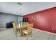 Bright dining room features stylish lighting, wood floors, and contrasting gray and red paint at 11257 Persimmon Ave, Weeki Wachee, FL 34614