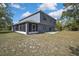 Stunning exterior view of a two-story home, featuring a screened-in porch and ample yard space at 11257 Persimmon Ave, Weeki Wachee, FL 34614