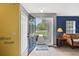Bright foyer featuring light hardwood floors, a blue accent wall, and a view towards the front yard at 11257 Persimmon Ave, Weeki Wachee, FL 34614
