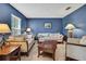 Cozy living room showcasing modern lamps, comfortable sofas, and a dark blue accent wall for a serene ambiance at 11257 Persimmon Ave, Weeki Wachee, FL 34614