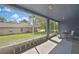 Relaxing screened-in porch with comfortable seating and a view of the backyard at 11257 Persimmon Ave, Weeki Wachee, FL 34614