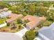 Aerial view of a charming single-story home surrounded by mature landscaping and lush trees at 11284 Hickory Ridge Ct, Spring Hill, FL 34609