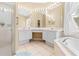 Bathroom featuring soaking tub, vanity, and a glass enclosed shower at 11284 Hickory Ridge Ct, Spring Hill, FL 34609