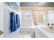 Bright bathroom featuring a tub, toilet, and a framed art piece above the towel rack at 11284 Hickory Ridge Ct, Spring Hill, FL 34609