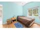 Light-filled bedroom with vaulted ceiling, featuring wood floors and a cozy atmosphere at 11284 Hickory Ridge Ct, Spring Hill, FL 34609