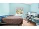 Bedroom with vaulted ceiling, hardwood flooring, desk, and natural light at 11284 Hickory Ridge Ct, Spring Hill, FL 34609