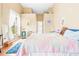 Sunlit bedroom showcasing a colorful quilt, high ceilings, and decorative accents at 11284 Hickory Ridge Ct, Spring Hill, FL 34609
