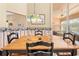 Traditional dining room featuring wood table, black chairs, and a decorative Tiffany-style hanging light fixture at 11284 Hickory Ridge Ct, Spring Hill, FL 34609