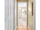 Hallway view into a bathroom featuring tile flooring, tub, and natural light at 11284 Hickory Ridge Ct, Spring Hill, FL 34609