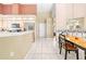 Bright, open kitchen featuring white cabinets, stainless steel appliances and decorative shelving at 11284 Hickory Ridge Ct, Spring Hill, FL 34609