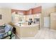 Bright eat-in kitchen featuring light wood cabinets, a countertop, and updated appliances at 11284 Hickory Ridge Ct, Spring Hill, FL 34609