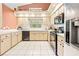 Bright kitchen with neutral cabinets and updated appliances, plus a view to the yard at 11284 Hickory Ridge Ct, Spring Hill, FL 34609