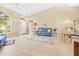 Bright living room featuring high ceilings, large windows, and modern flooring, and neutral colored walls at 11284 Hickory Ridge Ct, Spring Hill, FL 34609