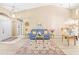 Bright living room with high ceilings, neutral walls, and attractive decor with light, wood-look floors at 11284 Hickory Ridge Ct, Spring Hill, FL 34609
