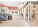 Bright living area leading to a sunroom, with tile flooring and comfortable seating at 11284 Hickory Ridge Ct, Spring Hill, FL 34609