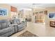 Spacious living area with access to lanai, light tile flooring, and comfortable seating at 11284 Hickory Ridge Ct, Spring Hill, FL 34609