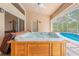 Covered patio featuring a hot tub next to a screened-in pool area at 11284 Hickory Ridge Ct, Spring Hill, FL 34609