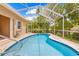 A screened-in pool, with clear water, is accessible from inside of the home at 11284 Hickory Ridge Ct, Spring Hill, FL 34609