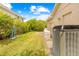 The side yard features an AC unit and mature landscaping that provides privacy at 11284 Hickory Ridge Ct, Spring Hill, FL 34609
