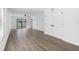 Spacious living room with modern flooring, ceiling fan, large sliding glass doors, and abundant natural light at 116 Hallam Ct, Spring Hill, FL 34606