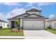 Charming single-Gathering home with a two-car garage, manicured lawn, and modern architectural details at 124 Hallam Ct, Spring Hill, FL 34606