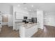 Bright kitchen featuring an island, stainless steel appliances, granite countertops, and modern fixtures at 124 Hallam Ct, Spring Hill, FL 34606