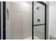 Modern tiled shower with glass door and sleek fixtures at 124 Hallam Ct, Spring Hill, FL 34606