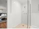 Walk-in shower features white subway tile, a glass door, and multiple shower heads at 125 29Th N St, St Petersburg, FL 33713