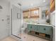 Renovated bathroom with modern fixtures, a glass shower, and a stylish vanity at 125 29Th N St, St Petersburg, FL 33713