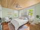Bright bedroom with wood plank ceilings and hardwood floors at 125 29Th N St, St Petersburg, FL 33713